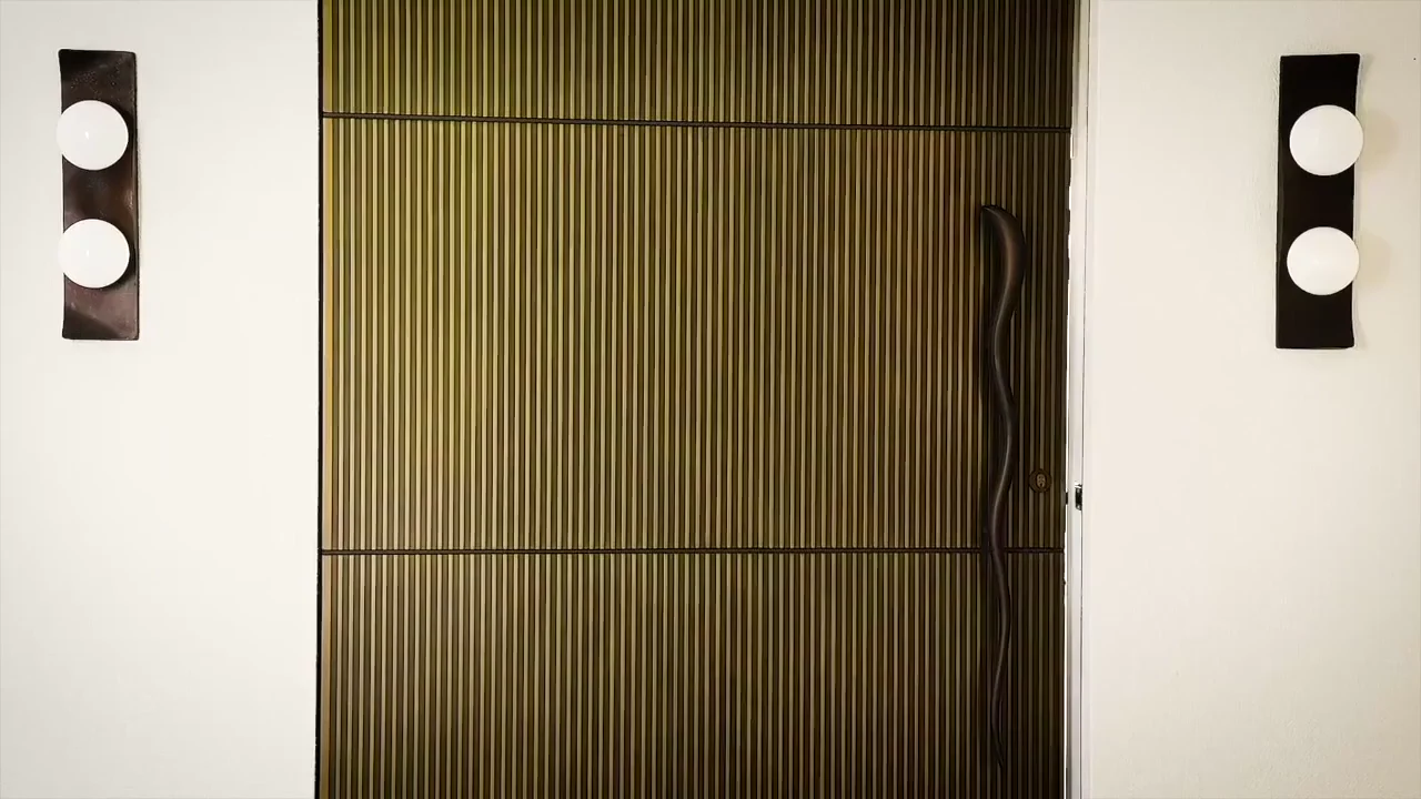 An Axolotl entrance door opening into an architectural interior