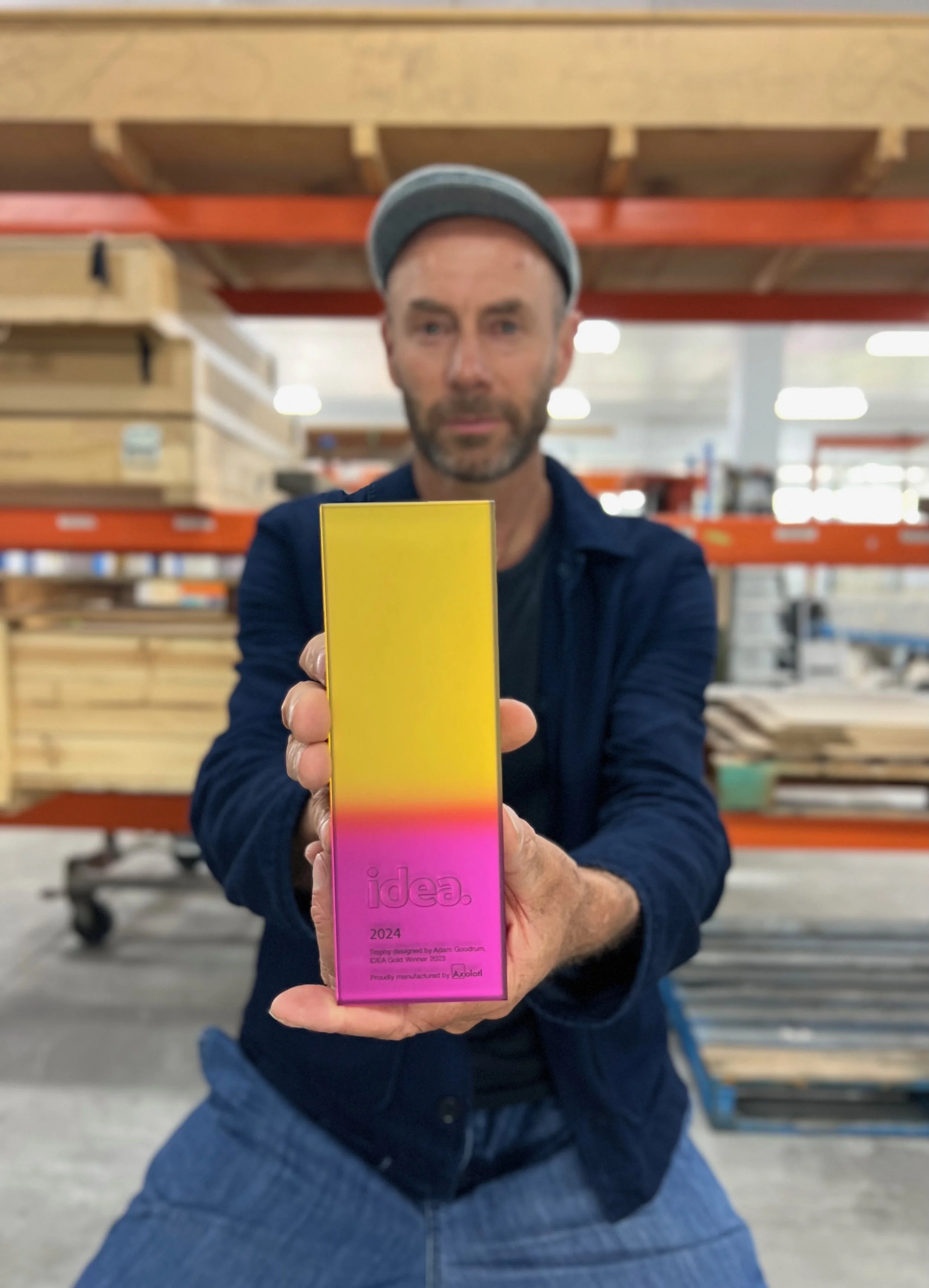 Adam Goodrum presents the 2024 IDEA Awards trophy.