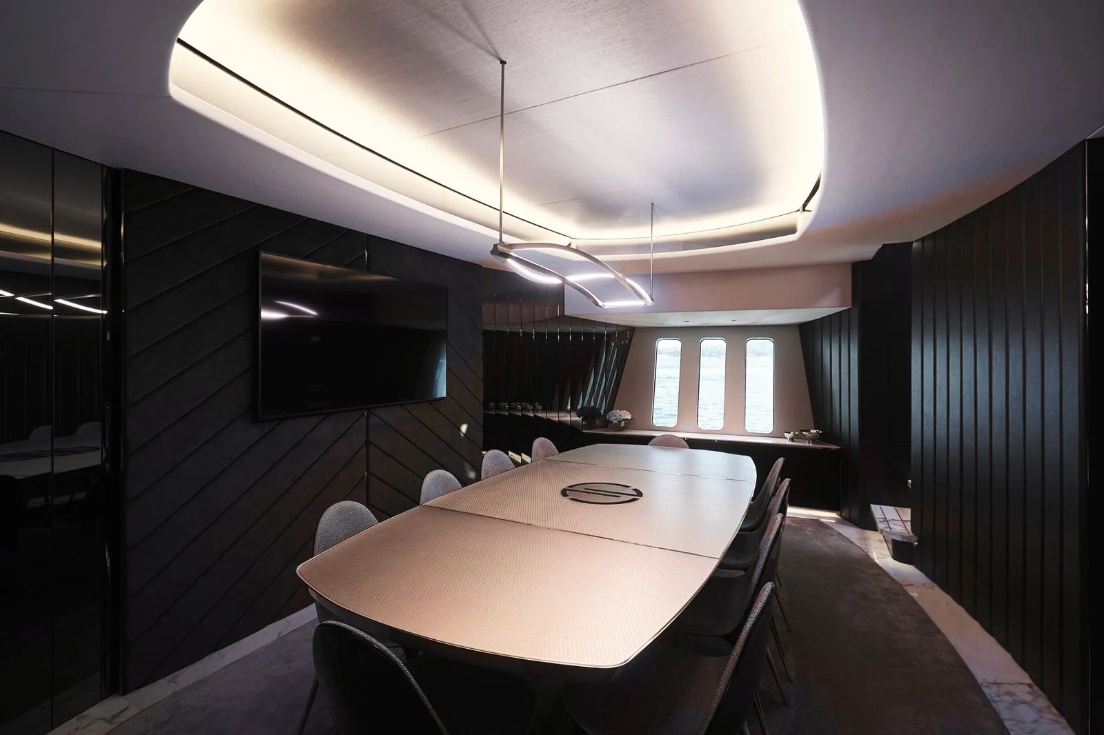 An angled view of the custom glass dining table. Interior design by Henderson & Co.
